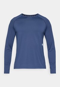 Marineblauw shirt met lange mouwen gemaakt van gladde stof. Voorzien van een ronde hals en raglanmouwen. Heeft een klein logo aan de onderkant.
