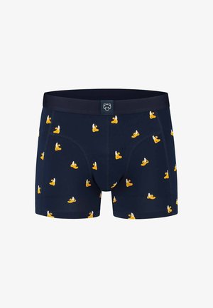 Temno modri boksarji iz mehkega blaga z ponavljajočim se vzorcem rumenih gumijastih račk. Vključujejo enobarvno elastiko in sprednji žep.