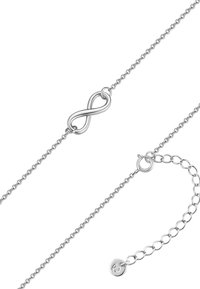Sidabrinė grandinėlė su begalybės simboliu, turinti subtilią tekstūrą ir užsegimą, suteikiantį reguliuojamą ilgį.