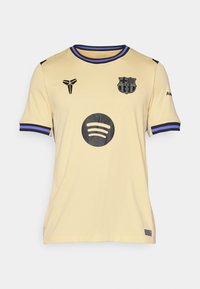 Svijetložuta nogometna majica s crnim logotipima, ljubičastim detaljima na manžetama i okruglim Spotify logotipom sprijeda. Materijal je teksturirani poliester.