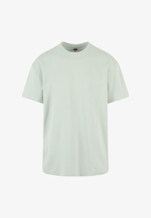 T-shirt en coton vert clair avec un col rond, des manches courtes et une coupe décontractée. Présente une étiquette au cou. Texture douce.