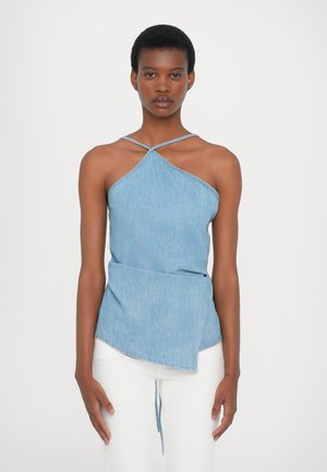 Denim halter top with crisscross straps, asymmetrical hem, and light blue color. Smooth texture with minimal stitching detail.
