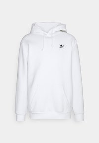 Vit huvtröja i mjukt material, med en framficka och en liten svart Adidas-logotyp på bröstet. Justerbara dragsnören.