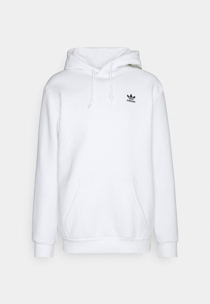 Bílá mikina s kapucí vyrobená z měkké tkaniny, s přední kapsou a malým černým logem Adidas na hrudi. Nastavitelné šňůrky.