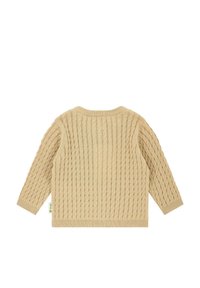 Béžový svetr z pleteniny s dlouhými rukávy a kulatým výstřihem. Textura je silná s ribovanými manžetami a lemem. Malá značková etiketa po straně.