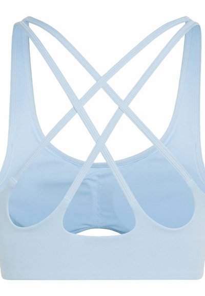 Light blue sports bra with thin crisscross straps and a small cutout detail on the back, made of smooth stretch fabric.