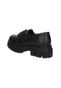 Scarpa di pelle nera con suola spessa, punta rotonda, design con lacci e dettagli di cucitura sottili sulla tomaia.