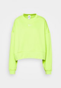 Neonově zelená krátká mikina z měkké látky. Má kulatý výstřih, volný střih a bílý logo Nike na hrudi. Žebrované manžety.