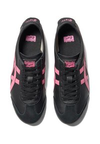 Black sneakers with pink accents, featuring a smooth leather surface, rounded toe, and textured laces. Logo visible on tongue and heel.