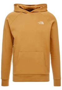 Sudadera con capucha en color mostaza, fabricada en tejido suave. Presenta un bolsillo tipo canguro, puños de canalé y un pequeño logo en el pecho.