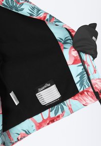 Floral pattern jacket interior with light blue fabric, featuring pink flamingos and green leaves. Includes a black label with contact details.