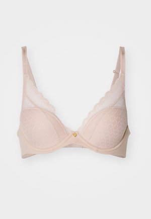 Beige lace-trimmed bra with a patterned mesh design, padded cups, adjustable straps, and a small gold accent at the center.