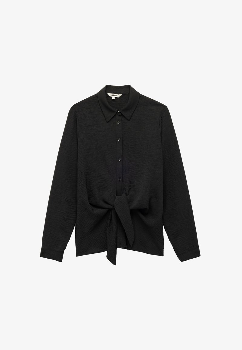Black long-sleeve shirt with a collar, featuring button closure and a tied front. Made of textured fabric with a soft finish.