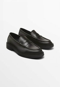 Black leather loafers with a smooth finish, featuring a stitched outline and horizontal stripe detail across the front. Thick black sole.