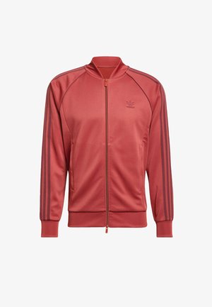 Rote Sportjacke mit Reißverschluss, geripptem Kragen und Bündchen. Verfügt über drei dunkle Streifen entlang der Ärmel und ein dezentes Logo auf der Brust.