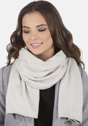 Sciarpa a maglia grigia chiara drappeggiata attorno al collo, con una texture morbida e una finitura liscia. Le estremità pendono in modo uniforme, complementando un cappotto grigio.