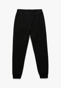 Pantalones de chándal negros de algodón con cintura elástica y puños estrechos. Presentan una textura suave y un diseño clásico, adecuados para un uso casual.