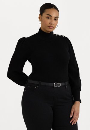 Black ribbed knit turtleneck sweater featuring puff sleeves and decorative silver buttons on one shoulder. Worn with high-waisted black jeans and belt.