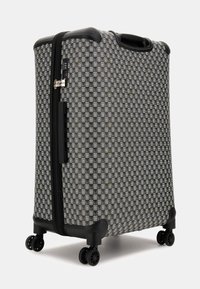 Black and grey checked wheeled suitcase with a textured surface, dual zippers, top handle, and four wheels for easy mobility.