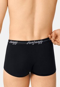 Black boxer shorts with a soft, elastic waistband featuring grey "sloggi" branding. Smooth fabric with a snug fit, with no visible patterns.