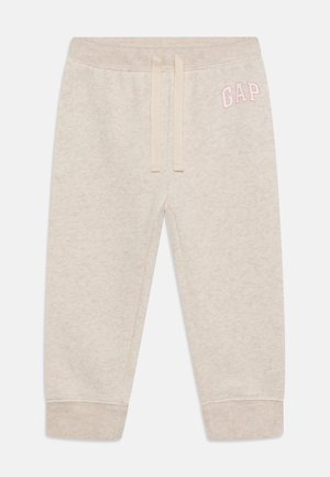 Lysebeige småbørns joggingbukser med ribkanter, justerbar snørre i taljen og pink GAP-logo på øverste venstre lår.