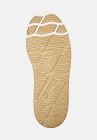 Rubber shoe sole in beige with a wavy texture, featuring grooves for traction and "CAMPER" branding, with a white toe cap accent.