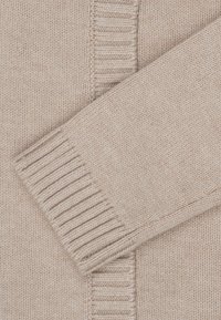 Maglione beige in maglia con tessuto testurizzato, polsini a coste e un design semplice. Tessuto morbido e liscio con coste a contrasto.