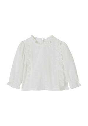 White long-sleeve blouse with eyelet floral pattern, ruffled collar, and ruffle trim along front and sleeve cuffs.