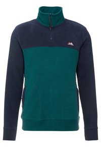 Pile per maglione in verde acqua e blu navy, caratterizzato da un collo alto, cerniera e tasche laterali con una texture liscia. Logo della montagna mostrato.