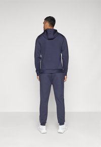 Castore SCUBA JOGGERS - Tracksuit bottoms - midnight navy