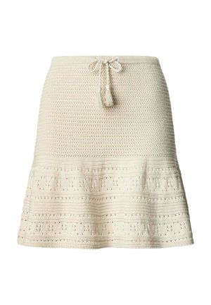 Cremerock aus Strick mit strukturierten Mustern und einem Tunnelzugbund mit Quasten, der am Saum leicht ausgestellt ist.