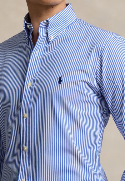 Blue and white striped button-up shirt, featuring a classic collar, fastened with buttons, with a small logo on the chest.