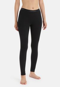 Black leggings made from a smooth, stretchy fabric with a fitted design. Features a wide waistband with "icebreaker" logo.