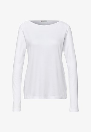 Dlouhý rukáv bílého trička z měkké bavlny, s kulatým výstřihem a volným střihem. Hladká textura bez vzorů či kovových doplňků.
