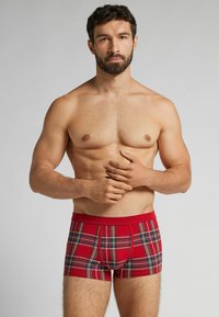 Czerwone bokserki w kratę o dopasowanym kroju, z jednolitym czerwonym pasem i kontrastującymi niebieskimi oraz żółtymi paskami w wzorze.