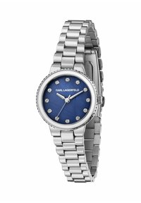 Silverfärgad metallklocka med en rund blå urtavla, prydd med kristallmarkörer och ett polerat armband. Logotypen syns under klockan 12.