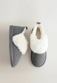 Gray slippers made of suede with a white faux fur collar. Features a slip-on design and a textured gray sole.