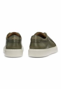 Green leather sneakers with a white rubber sole, rounded shape, minimalistic design, and subtle accent line along the heel.