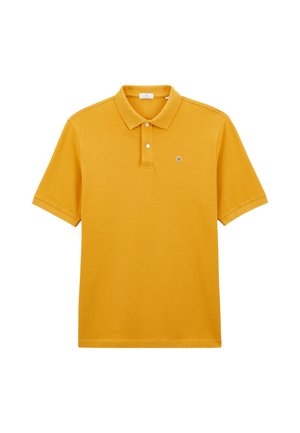 Polo shirt jaune en coton, doté d'un col classique, de deux boutons et d'un petit logo sur la poitrine gauche. Manches courtes.