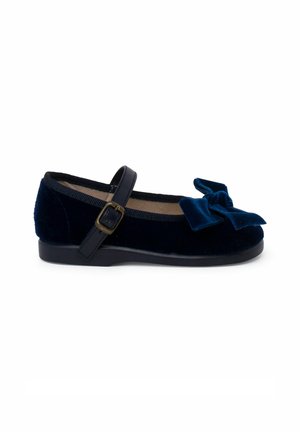 Navy velvet Mary Jane shoe with a wide bow on the front, adjustable strap, and a sturdy black sole. Smooth texture with a classic design.