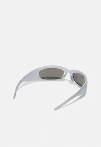 Gray plastic sunglasses with wraparound design, dark lenses, and subtle logo on the side. Lightweight and curved for a secure fit.