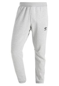 Grå sweatpants i mjuk bomullsmix, med tapered bendesign, elastisk midja och en svart Adidas-logotyp på vänster lår.