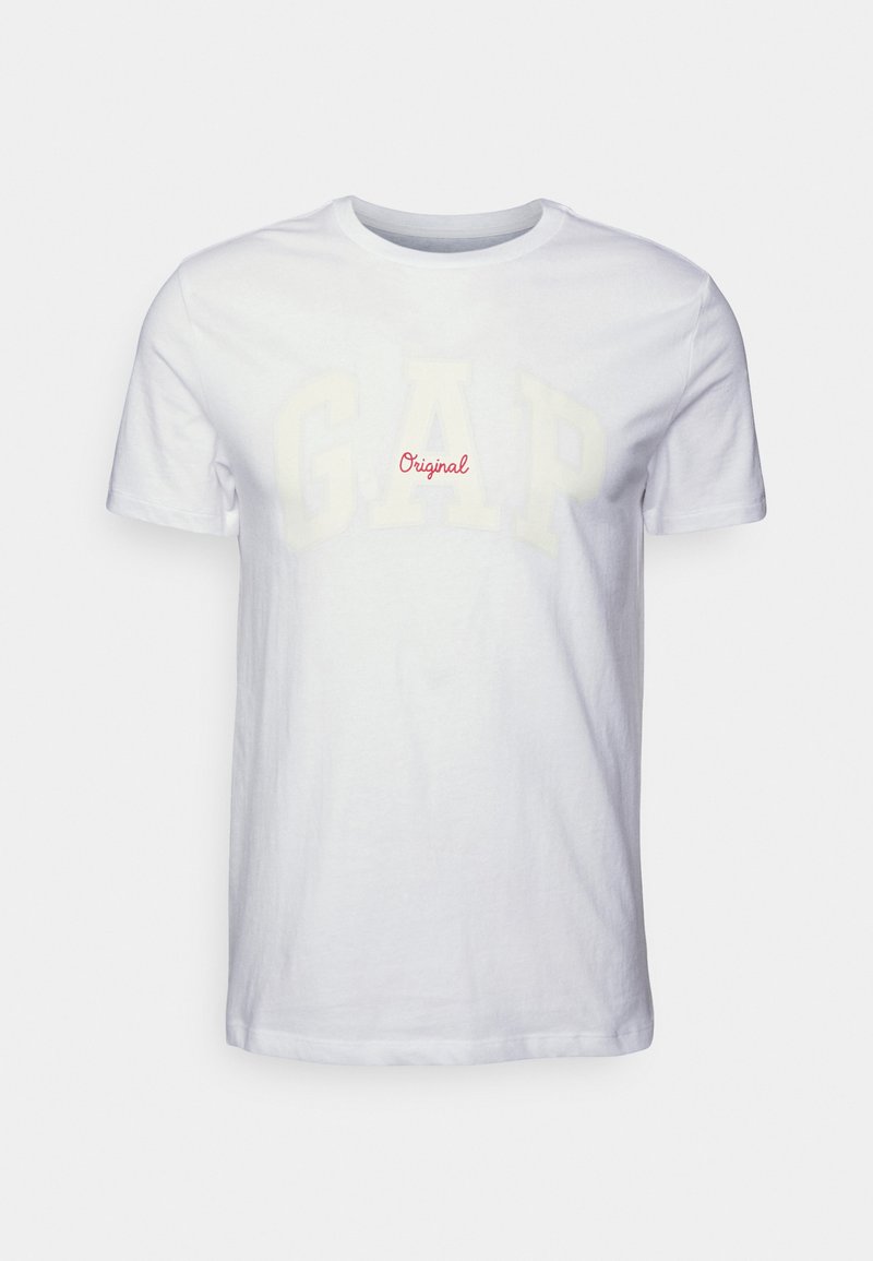 Hvid bomulds T-shirt med et stort, falmet "G.A.P." print i lys gul og "Original" i rød, med en klassisk rund halsdesign.