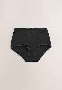 Fekete magas derekú női fehérnemű, elöl kis masnival a derékrésznél, világos felületen elhelyezve.