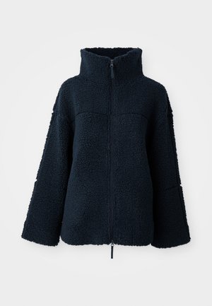 Veste en polaire texturée bleu marine avec col haut et fermeture éclair sur toute la longueur, manches longues et coupe ample.
