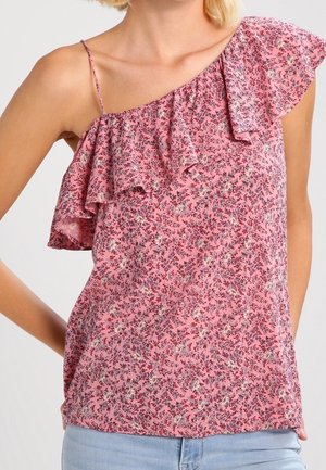 Roze mouwloos topje met klein bloemenprint, geplooide off-shoulder halslijn en dun spaghettibandje aan één kant, gedragen met lichtblauwe spijkerbroek.