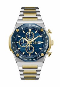 Ceas cronograf cu un cadran texturat albastru, accente aurii, brățară din oțel inoxidabil argintiu și auriu, și bezel cu tachimetru. Dispune de trei sub-cadrane.