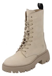 Bota de tobillo beige con cordones, hecha de cuero suave, con una suela gruesa y dentada y un tira en la parte trasera. Con un logotipo en el lado.