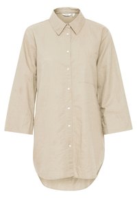 Beige langærmet skjorte lavet af en hørblanding, med klassisk krave, knaplukning foran, en enkelt lomme og buet kant.