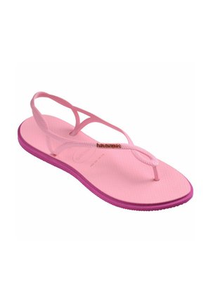 Pink rubber flip-flop sandal with a textured footbed and braided straps; features a contrasting purple sole and a gold logo on the strap.